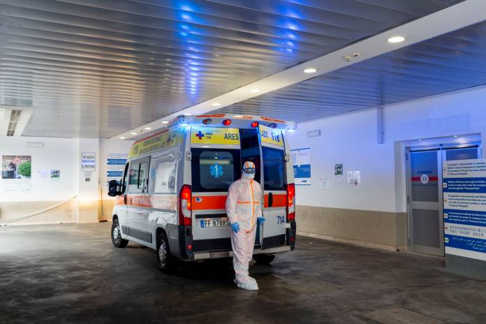 A medical worker in a protective suit stands by an ambulance in the emergency room of the Gemelli Hospital, where coronavirus patients are looked after, in Rome A medical worker in a protective suit stands by an ambulance in the emergency room of the Gemelli Hospital, where coronavirus patients are looked after, in Rome