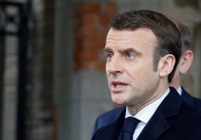 French President Emmanuel Macron speaks to the media, after casting his ballot during the first round of the mayoral elections in Le Touquet