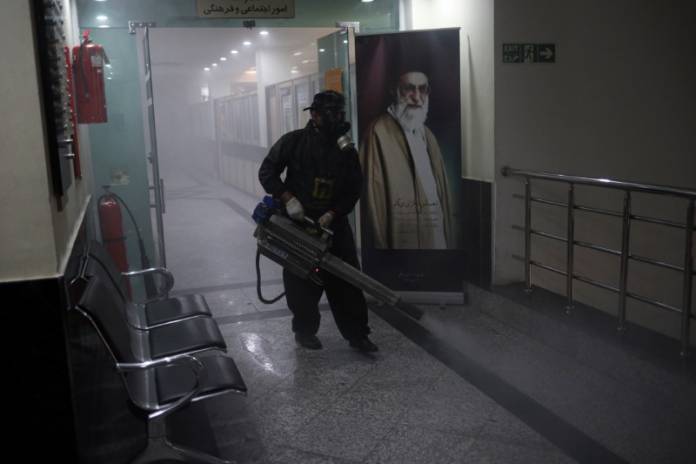 A member of firefighters wears a protective face mask, amid fear of coronavirus disease (COVID-19), as he disinfects a municipality building, ahead of the Iranian New Year Nowruz, March 20, in Tehran A member of firefighters wears a protective face mask, amid fear of coronavirus disease (COVID-19), as he disinfects a municipality building, ahead of the Iranian New Year Nowruz, March 20, in Tehran