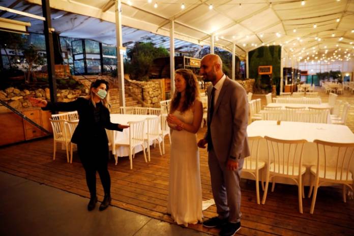 Israeli couple Roni Ben-Ari and Yonatan Meushar, look on as they get married at Ein Hemed Forest Wedding Venue, in Ein Hemed, Israel Israeli couple Roni Ben-Ari and Yonatan Meushar, look on as they get married at Ein Hemed Forest Wedding Venue, in Ein Hemed, Israel