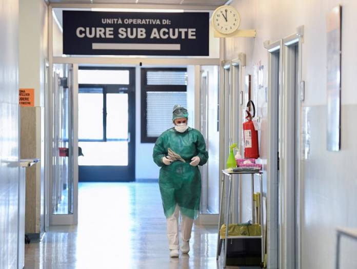Medical worker wearing a protective mask and suit walks in an intensive care unit at the Oglio Po hospital in Cremona Medical worker wearing a protective mask and suit walks in an intensive care unit at the Oglio Po hospital in Cremona