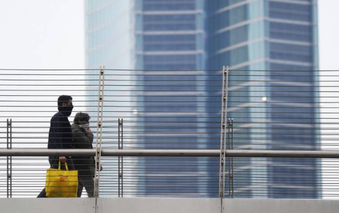 People wearing protective face masks walk as the spread of coronavirus disease (COVID-19) continues, in Milan People wearing protective face masks walk as the spread of coronavirus disease (COVID-19) continues, in Milan