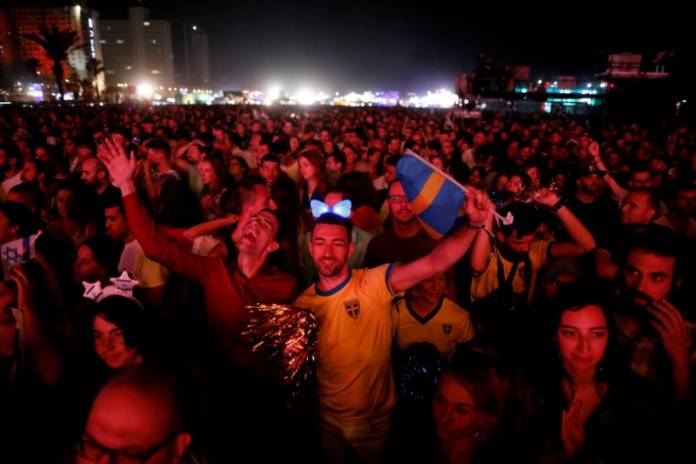 FILE PHOTO: Fans react as they listen to the 2019 Eurovision song contest final in the fans zone by the beach in Tel Aviv, Israel FILE PHOTO: Fans react as they listen to the 2019 Eurovision song contest final in the fans zone by the beach in Tel Aviv, Israel