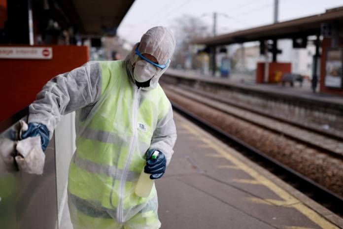 FILE PHOTO: A worker cleans the train station with disinfectant to slow the rate of the coronavirus disease in Suresnes FILE PHOTO: A worker cleans the train station with disinfectant to slow the rate of the coronavirus disease in Suresnes