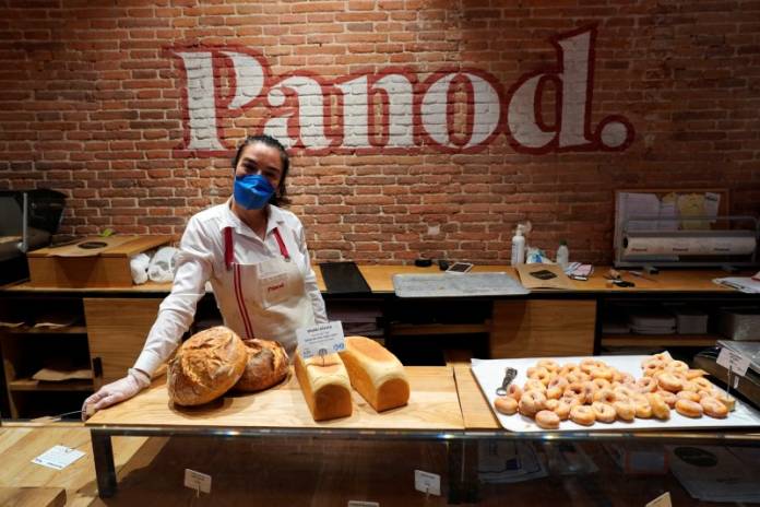 Sonia poses in a shop during a partial lockdown as part of a 15-day state of emergency to combat the spread of coronavirus disease (COVID-19) in Madrid