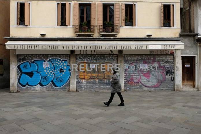 A person walks in a nearly empty Venice after Italy tightened the lockdown measures to combat the coronavirus disease (COVID-19) outbreak in Venice A person walks in a nearly empty Venice after Italy tightened the lockdown measures to combat the coronavirus disease (COVID-19) outbreak in Venice