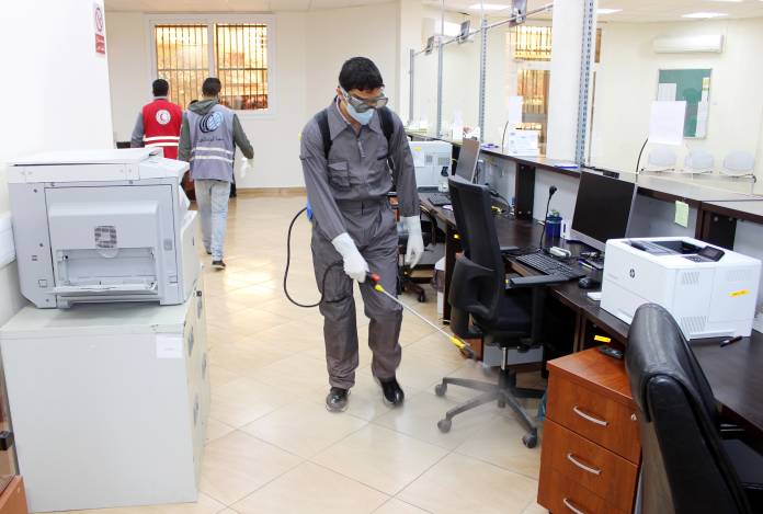 Members of Red Crescent spray disinfectants at government offices in Misrata Members of Red Crescent spray disinfectants at government offices in Misrata