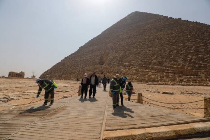 Members of the medical team spray disinfectant as a precautionary move amid concerns over the coronavirus disease (COVID-19) outbreak at the Great Pyramids, Giza, on the outskirts of Cairo Members of the medical team spray disinfectant as a precautionary move amid concerns over the coronavirus disease (COVID-19) outbreak at the Great Pyramids, Giza, on the outskirts of Cairo
