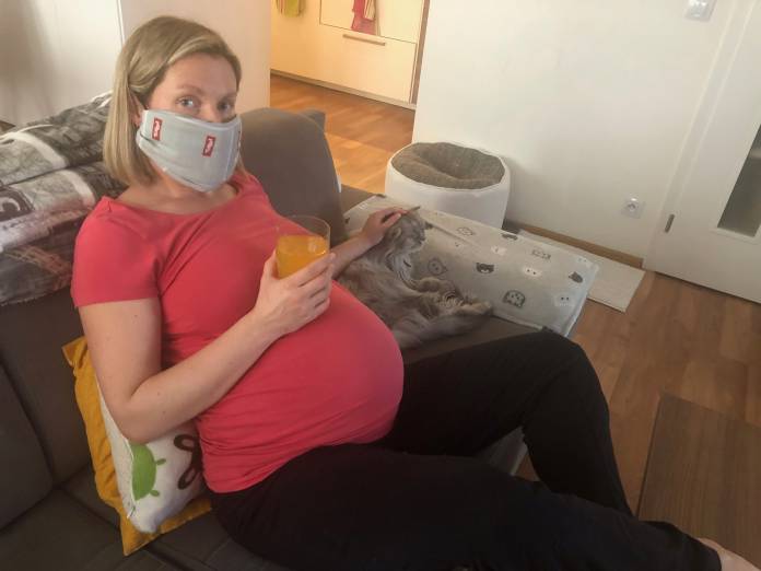 Veronika Legat pets her cat in her apartment in Prague