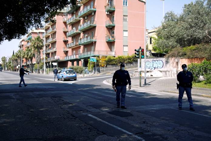FILE PHOTO: Police officers stand on a street to check people amid spread of the coronavirus disease (COVID-19), in Catania, Italy April 12, 2020. REUTERS/Antonio Parrinello