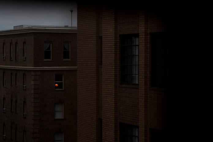 A lamp is illuminated inside of an apartment in the Dupont Circle neighborhood following Mayor Muriel Bowser's declaration of a state of emergency due to the coronavirus in Washington