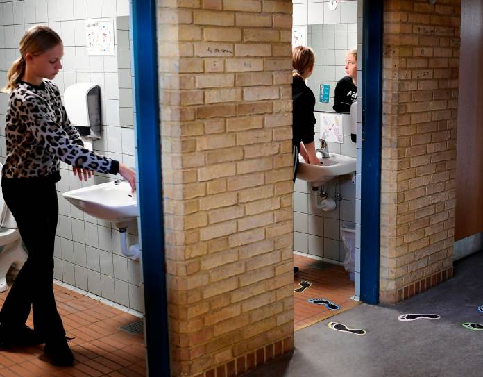 Students wash their hands in a break at Korshoejskolen following the coronavirus disease (COVID-19) outbreak north of Copenhagen in Randers