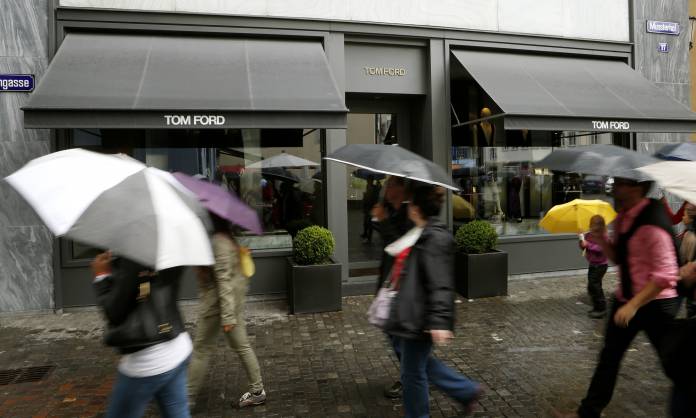 People walk past a store of U.S. fashion designer Tom Ford in Zurich