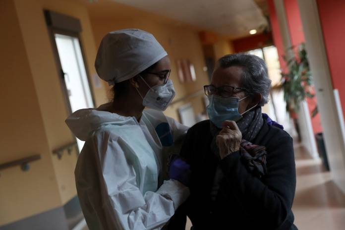 Occupational therapist Teresa Gallego hugs resident Trinidad Gilarranz during lockdown amid the coronavirus disease (COVID-19) outbreak at Oteruelo nursing home in Valverde del Majano