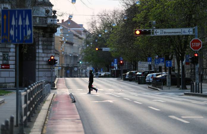FILE PHOTO: A man crossing a street as Croatia is stepping up measures to fight the coronavirus disease (COVID-19) outbreak