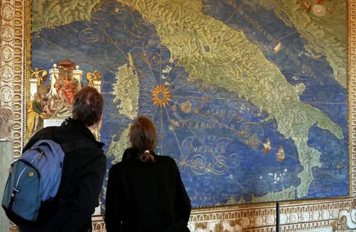 FILE PHOTO: Couple view a 16th century map of Italy in the Vatican Museum's Gallery of Maps at the Vatican
