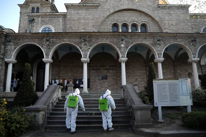 Workers spray disinfectant outside St Nedelya church