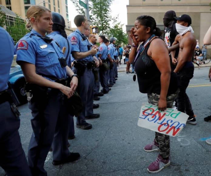A weeping protester confronts police during nationwide unrest following the death in Minneapolis police custody of George Floyd, in Raleigh