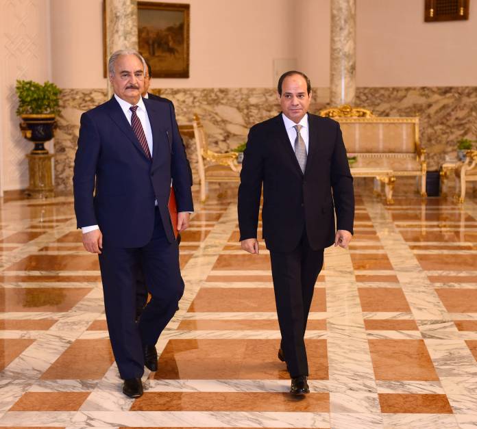 Libyan military commander Khalifa Haftar walks with Egyptian President Abdel Fattah al-Sisi at the Presidential Palace in Cairo