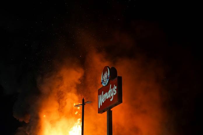 A Wendy’s burns following a rally against racial inequality and the police shooting death of Rayshard Brooks, in Atlanta