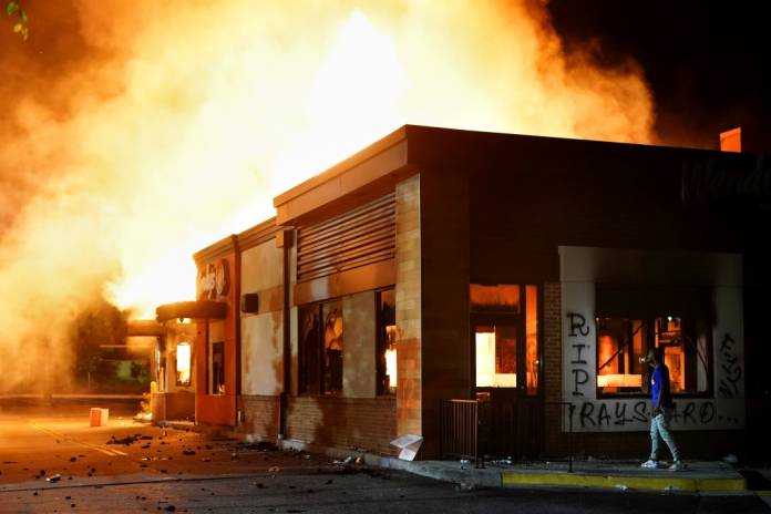 FILE PHOTO: A Wendy’s burns following a rally against racial inequality and the police shooting death of Rayshard Brooks, in Atlanta, Georgia, U.S. June 13, 2020. REUTERS/Elijah Nouvelage