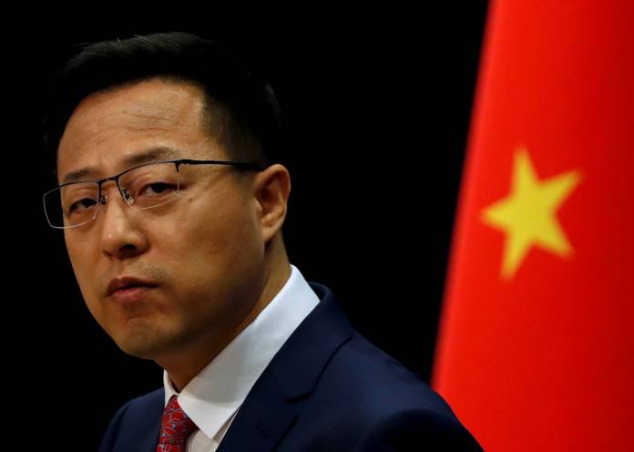FILE PHOTO: Chinese Foreign Ministry spokesman Zhao Lijian attends a news conference in Beijing