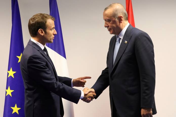 FILE PHOTO: France's President Emmanuel Macron shakes hands with Turkey's President Recep Tayyip Erdogan ahead of a bilateral meeting on the sidelines of a NATO summit in Brussels in 2018