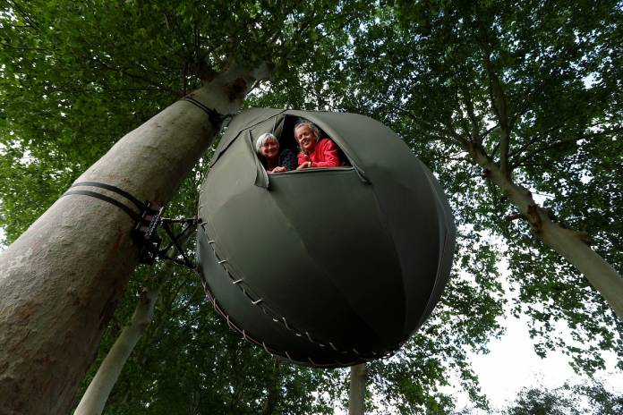 Tear drop-shaped tent hanging from a tree near Borgloon
