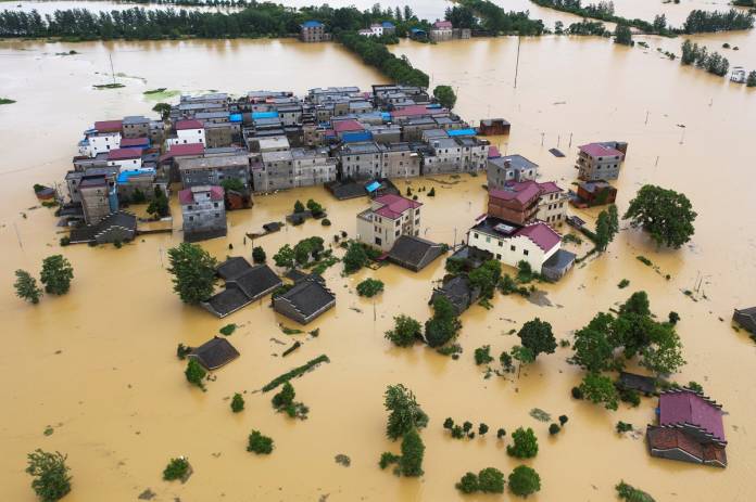 Aerial view shows buildings and farmlands partially submerged in floodwaters following heavy rainfall in Duchang