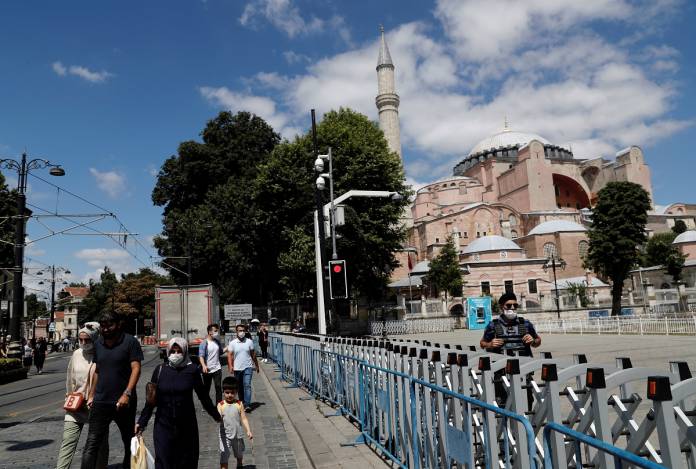 People walk past Hagia Sophia, or Ayasofya-i Kebir Camii, in Istanbul